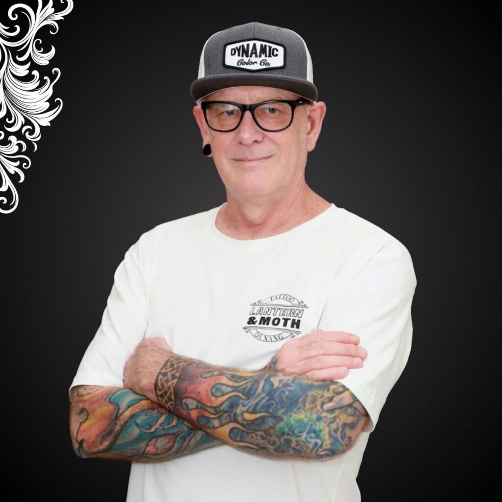 Professional tattoo artist creating intricate designs at a Tattoo Studio in Da Nang.