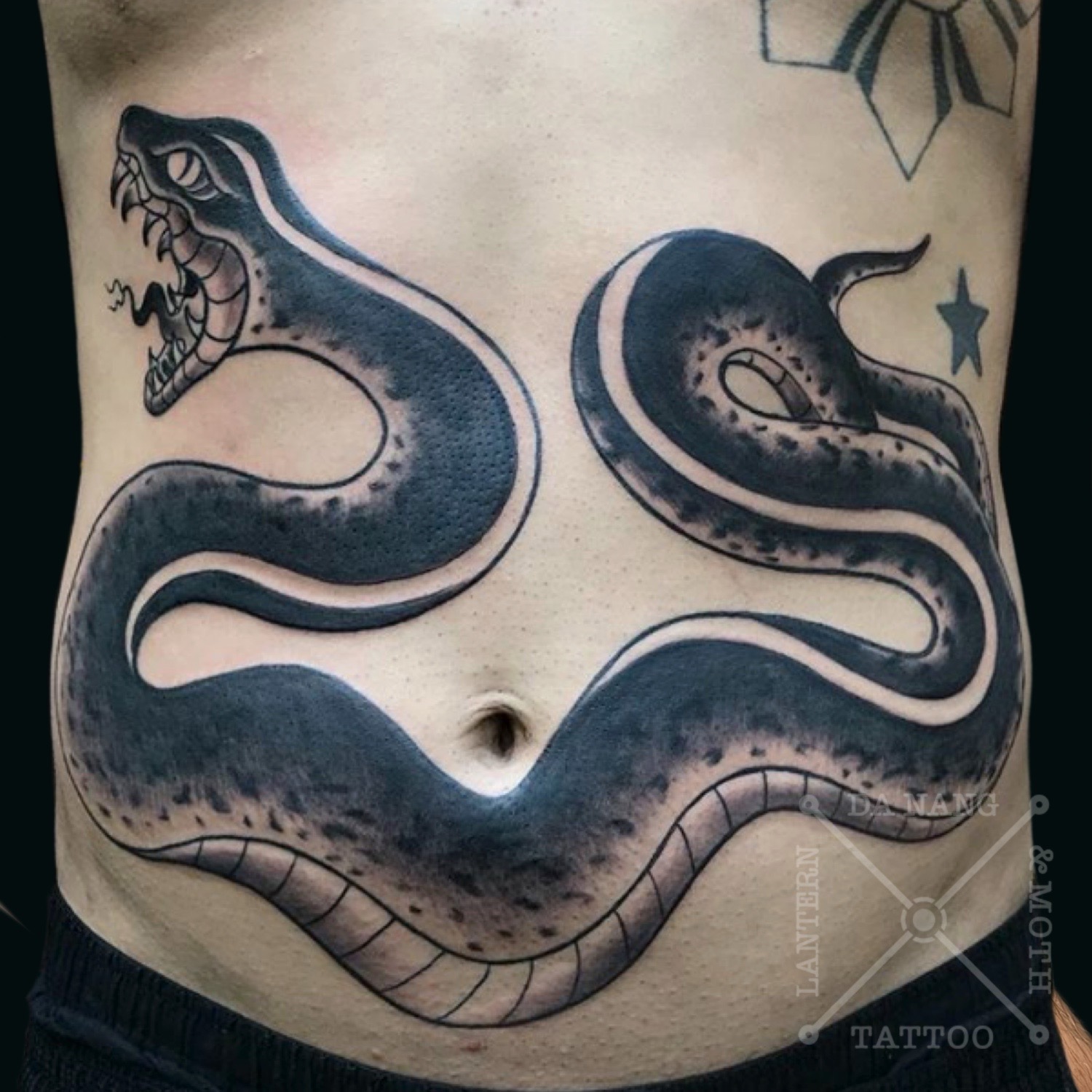 Black trad snake tattoo