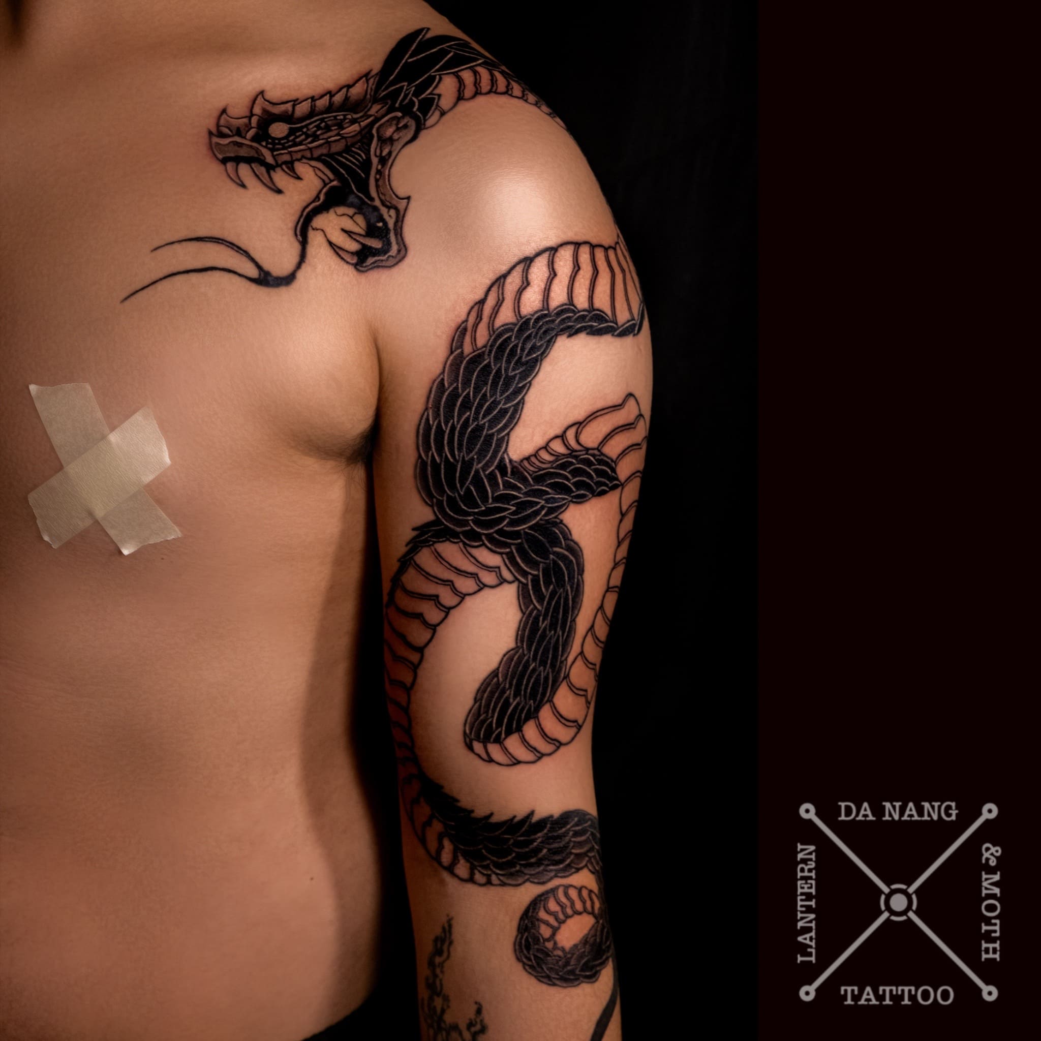 black-work-shoulder-dragon -design-da-nang-tattoo-shop-lantern-and-moth.