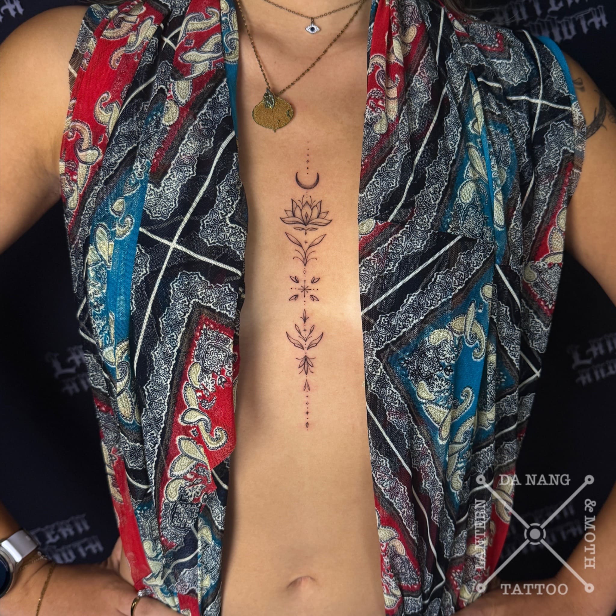 feminine-sternum-design-danang-tattoo-studio-lantern-and-moth.
